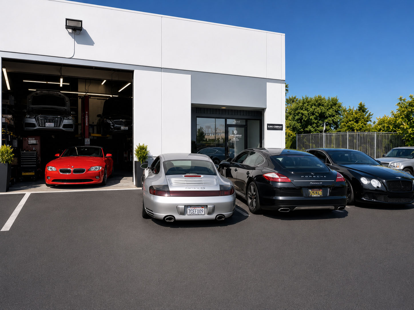 Luxury cars parked at auto shop