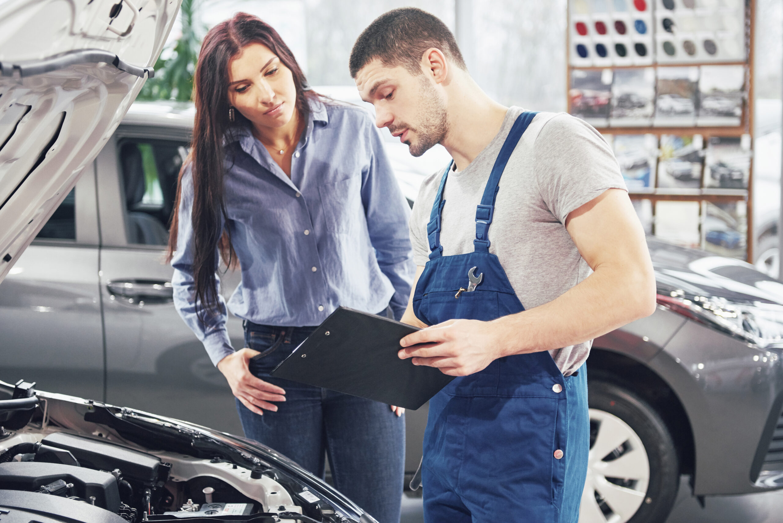 Mechanic explaining car repair to customer
