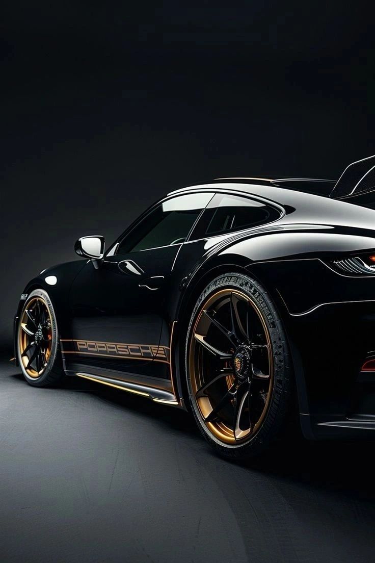 Black Porsche sports car with gold rims